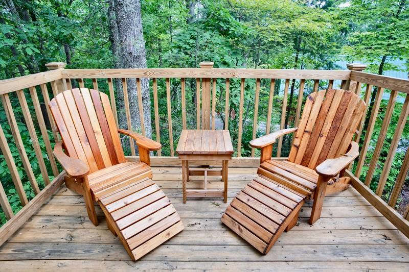 2 adirondack chairs and table on the porch